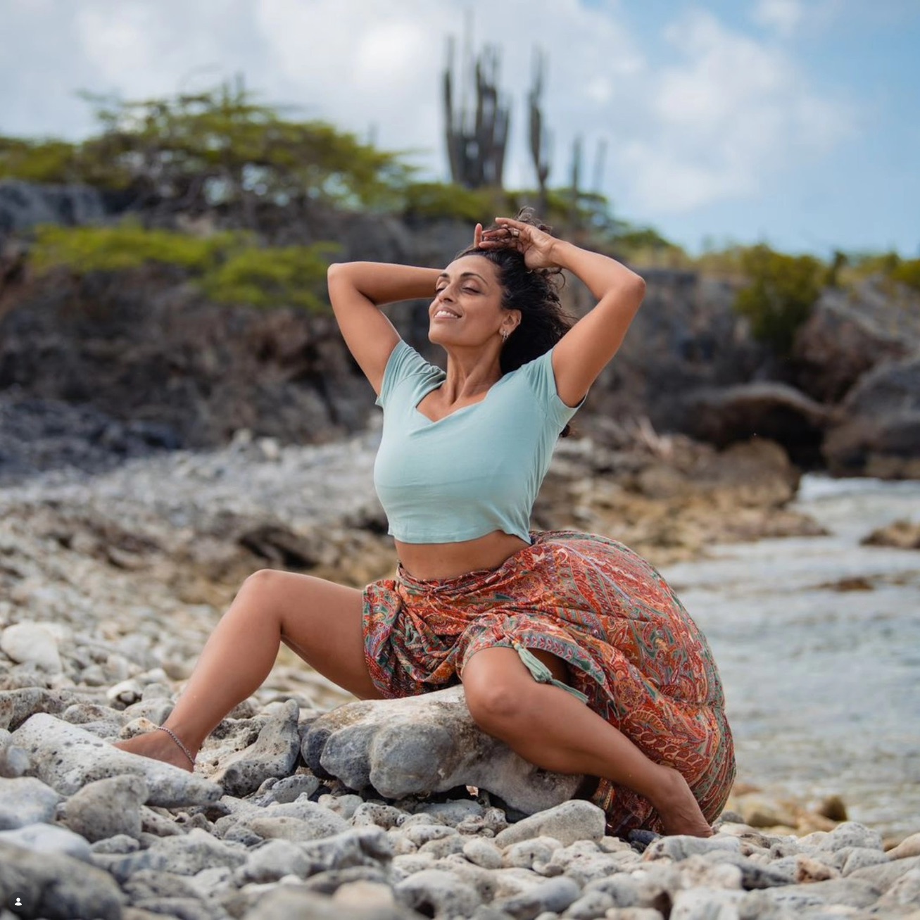 Tara moving among coastal rocks