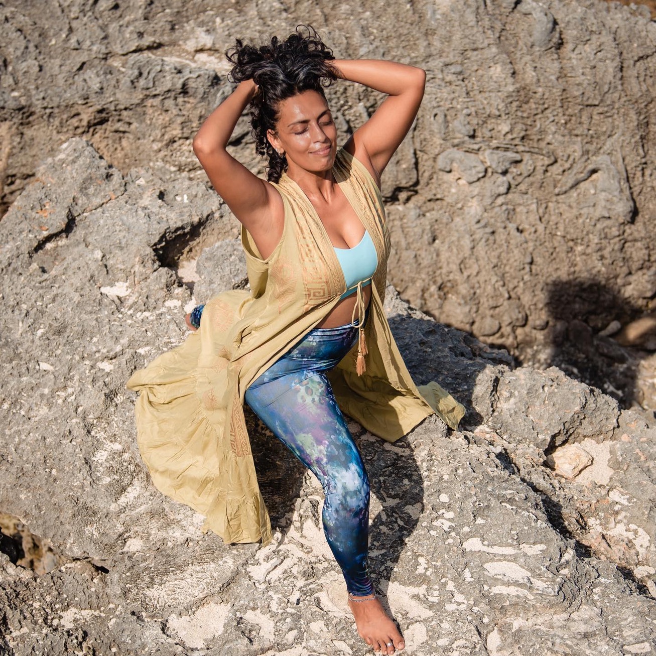 Tara resting on sunlit rocks